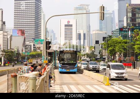 Jakarta / Indonesia - September 5, 2020. Pedestrians who will cross the Sudirman road while waiting for the Transjakarta bus to pass first. Stock Photo