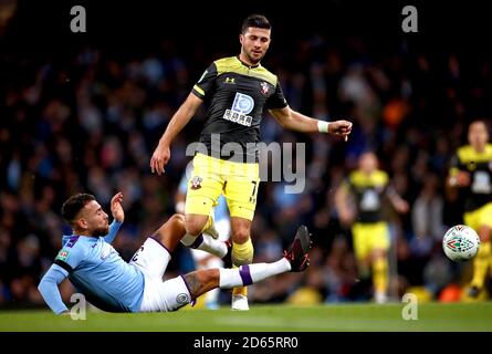 Manchester City's Nicolas Otamendi (left) and Southampton's Shane Long battle for the ball Stock Photo