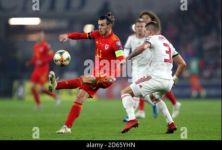 Wales' Gareth Bale (left) and Hungary's Adam Lang battle for the ball Stock Photo