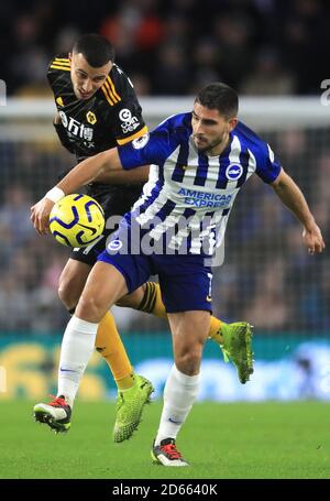 Wolverhampton Wanderers' Romain Saiss (left) and Brighton and Hove Albion's Neal Maupay battle for the ball Stock Photo