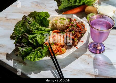 Korean beef bulgogi ssambap lettuce wraps with spicy kimchi and gochujang hot sauce Stock Photo