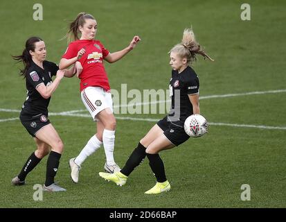 Manchester United's Ella Toone battles for the ball with Bristol City's Olivia Chance (left) and Katie Robinson (right)  Stock Photo