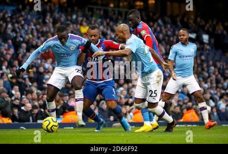 Manchester City's Benjamin Mendy (left) and Fernandinho battle for the ball with Crystal Palace's Jordan Ayew Stock Photo