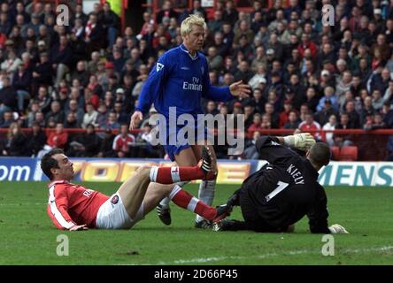 Charlton Athletic's goalkeeper Dean Kiely (r) saves as the feet of Chelsea's Eidur Gudjohnsen (c) as Charlton's defender Jorge Costa tries to tackle (l)  Stock Photo