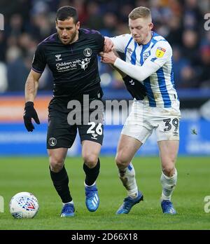 Charlton Athletic's Tomer Hemed (left) and Huddersfield Town's Lewis O'Brien battle for the ball Stock Photo