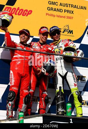 Ducati Marlboro rider Casey Stoner (AUS) celebrates his victory at the  GMC Australian Grand Prix with teamate Loris Capirossi (ITA) and Fiat Yamaha rider Valentino Rossi (ITA) Stock Photo