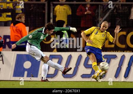 Northern Ireland's Kyle Lafferty (left) scores the second goal of the game. Stock Photo
