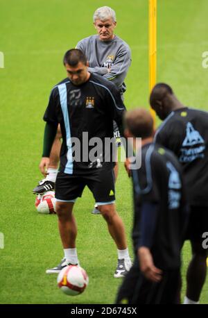 Manchester City manager Mark Hughes watches over training Stock Photo