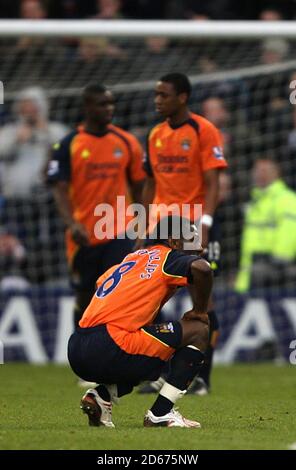 Manchester City players are left dejected after West Bromwich Albion's Roman Bednar (not in picture) scores his sides winning goal Stock Photo