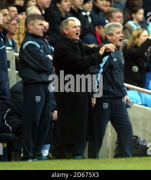 Manchester City's manager Kevin Keegan (r) urges on his team as do his coaching staff off Derek Fazackerley (l) and Arthur Cox (c) Stock Photo