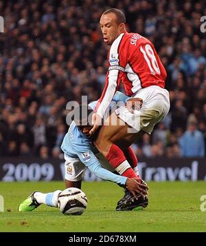 Manchester City's Shaun Wright-Phillips (left) falls onto Arsenal's Mikael Silvestre (right). Stock Photo