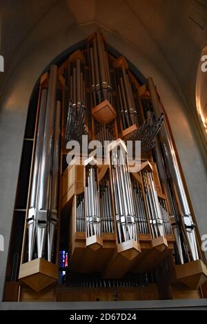 The Klais Organ, a pipe organ in Hallgrimskirkja Church, Reykjavik, Iceland. Shiny silver pipes mounted on light coloured angular designed wood. Stock Photo