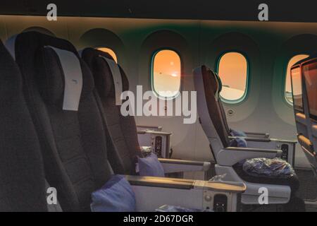 London, London, UK. 7 October 2020. Interior of a plane. British Airways flight. Showing World Traveller Plus, looking out the window to a sunset.  Credit: Sidney Bruere/Ģ����ý Live News Stock Photo