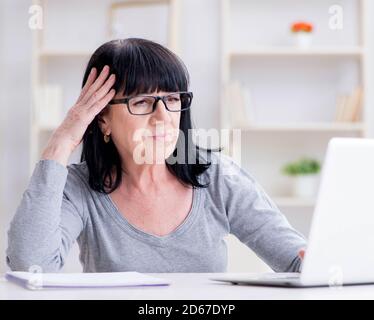 The senior woman struggling at computer Stock Photo