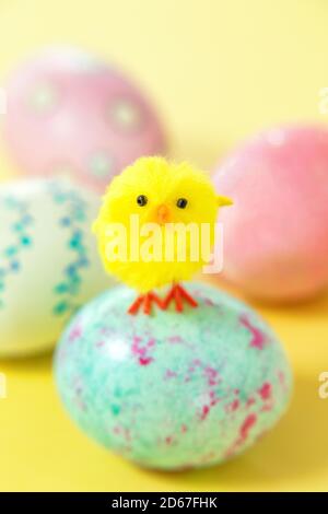 Yellow chick standing on Easter egg Stock Photo