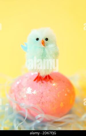 Blue chick standing on Easter egg Stock Photo