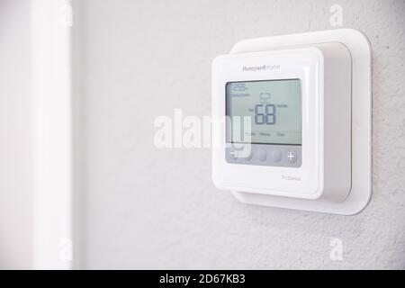 DENVER, COLORADO, UNITED STATES - Oct 12, 2020: A Honeywell Home Digital Thermostat sits on a wall, regulating temperature inside of a home. Stock Photo