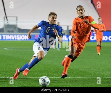 Bergamo, Italy. 14th Oct, 2020. Italy's Ciro Immobile (L) breaks through past Netherlands' Virgil van Dijk during their UEFA Nations League football match in Bergamo, Italy, Oct. 14, 2020. Credit: Alberto Lingria/Xinhua/Alamy Live News Stock Photo