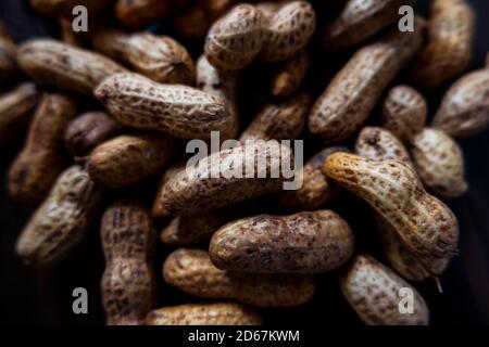 a closeup shot of wet peanuts shell group isolated on floor Stock Photo