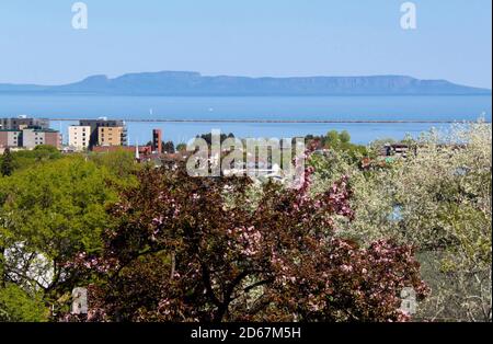 Spring trees in foreground with a view of the 'Sleeping Giant provincial park', set on a peninsula in Lake Superior, Ontario, Canada.