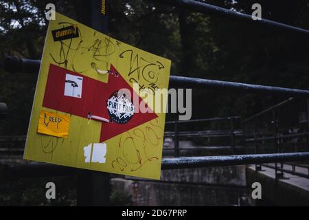 Graffiti on a sign with an arrow pointing right in New Hope Park during autumn. Stock Photo