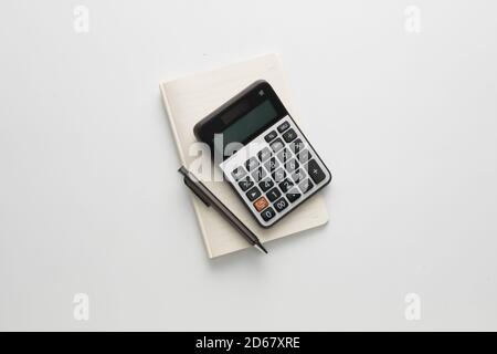 Pen , calculator and notes flat lay isolated in white backround Stock Photo