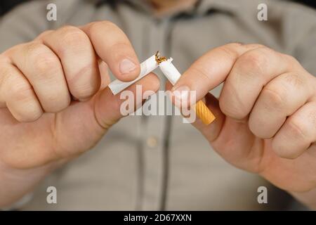 Man hands breaking the cigarette. Stop smoking in car concept. destroy cigarette by hand. Stock Photo