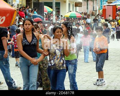 VILCABAMBA, ECUADOR - Oct 13, 2020: Vilcabamba, Loja / Ecuador - February 2 2008: Hispanic Kids Play Running with Water Shooting Guns at Carnival Stock Photo