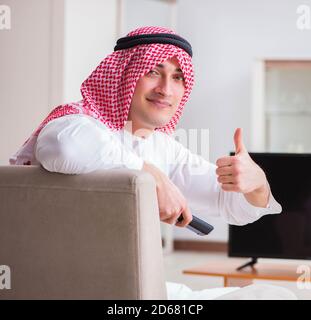 The arab businessman watching tv at home Stock Photo