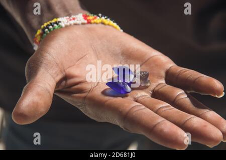 Smuggler showing smuggled precious and semi precious stones excavated in illegal mine, Mozambique Stock Photo