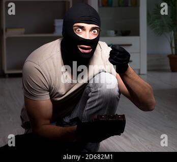 The burglar wearing balaclava mask at crime scene Stock Photo