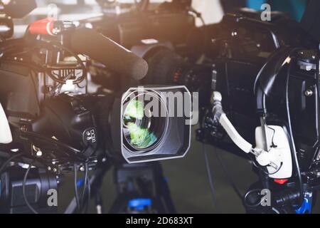 A few professional broadcast cameras are on the tripod ahead of the TV show. Broadcast Concept. Stock Photo