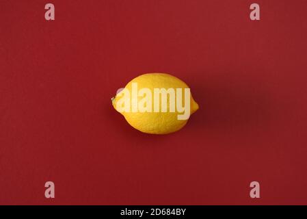 Whole lemon isolated on a red background Stock Photo