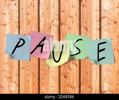 Colourful sticky notes on a board wall with the inscription pause Stock Photo