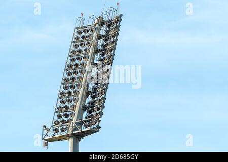 stadium lights or floodlights against a light blue sky during the day concept sports lighting and technology in Africa Stock Photo