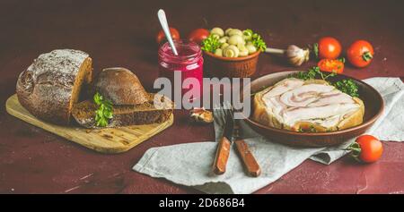 Tasty baking pork lard bacon fatback with black pepper and other herbs and spices in ceramic dish. Traditional Christmas Ukrainian, Hungarian, Polish Stock Photo