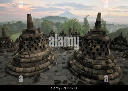 Stupas from Borobudur temple and Sumbing Volcano on Java Island, Indonesia Stock Photo