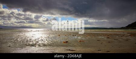 September and a dramatic sky frames the view looking south west from the shore at Ettrick Bay on Bute Stock Photo