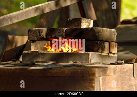 a burning forge made of bricks in nature Stock Photo