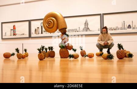 London, UK. 15th Oct, 2020. 'From the Birth of Paradise' by Edward Allington 1951-2017. Plastic pineappled tumble from a gold shell that seems to float in mid air. Tate Britain opens New Collection routes Credit: Mark Thomas/Alamy Live News Stock Photo