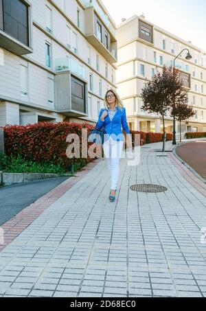 Businesswoman walking down the street Stock Photo