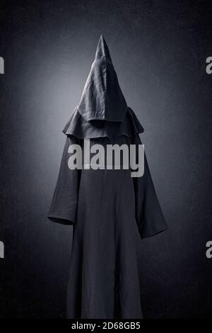 Scary figure in hooded cloak Stock Photo