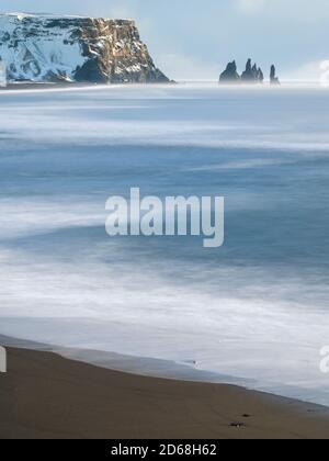 Coast of the North Atlantic near Vik y Myrdal during winter. Beach with the sea stacks called Reynisdrangar. europe, northern europe, scandinavia, ice Stock Photo