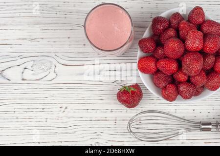 strawberry cocktail, blender and plate with strawberries Stock Photo