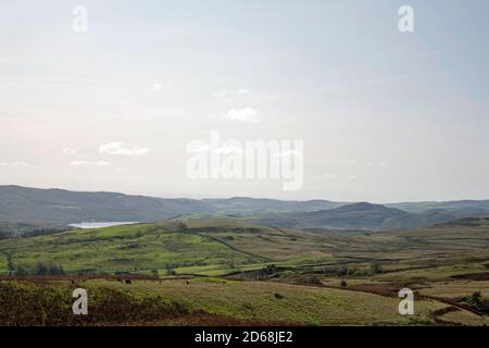 View from the Walna Scar Rd at the foot of the Old Man of Coniston over Torver High Common toward Coniston Water and Morecambe Bay Coniston Cumbria Stock Photo
