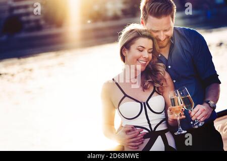 Happy young couple celebrating and drinking champagne a on a boat Stock Photo