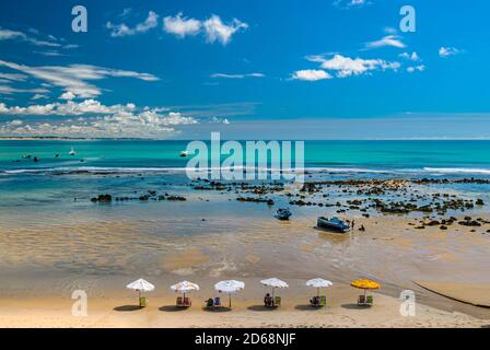 Pipa beach, Tibau do Sul, near Natal, Rio Grande do Norte, Brazil on May 7, 2008. Fisherman's boats anchored in the emerald sea on a sunny day. Stock Photo