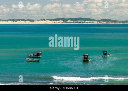 Pipa beach, Tibau do Sul, near Natal, Rio Grande do Norte, Brazil on May 7, 2008. Fisherman's boats anchored in the emerald sea on a sunny day. Stock Photo