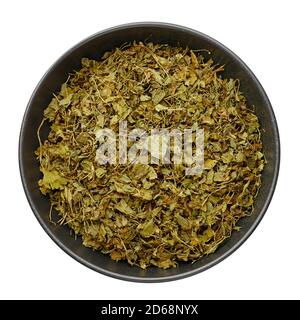 Dry Kasuri Methi or Fenugreek in black bowl isolated on white. Dried Fenugreek is is the popular seasoning of many asian cuisines. Stock Photo