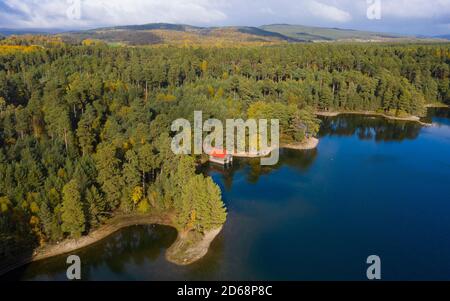 Aerial view of Loch Vaa and red boathouse  in Cairngorms National Park near Aviemore, Scottish Highlands, Scotland, UK Stock Photo